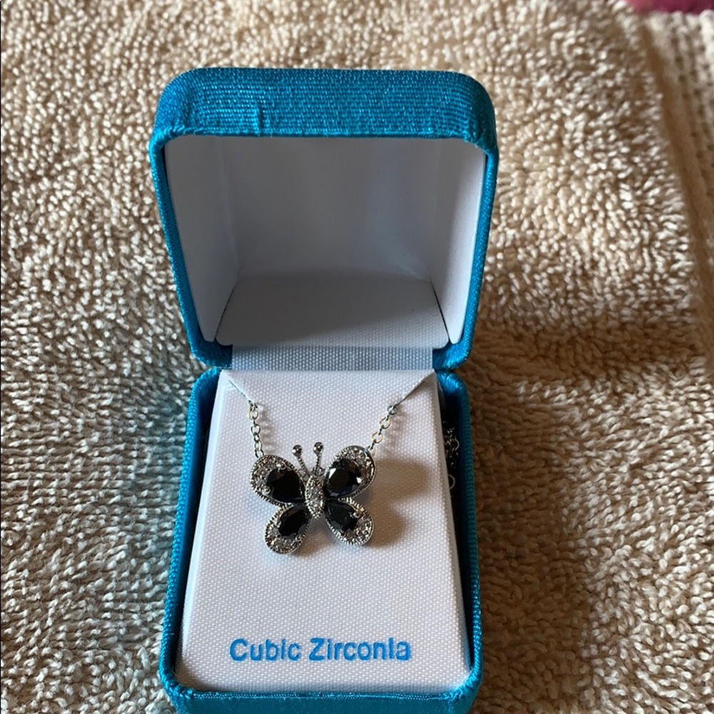 Silver-tone cubic zirconia butterfly necklace.